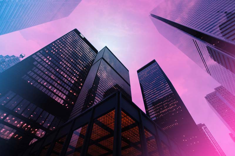 a street view up at three high-rise buildings with a pink and blue gradient overlaid on the image
